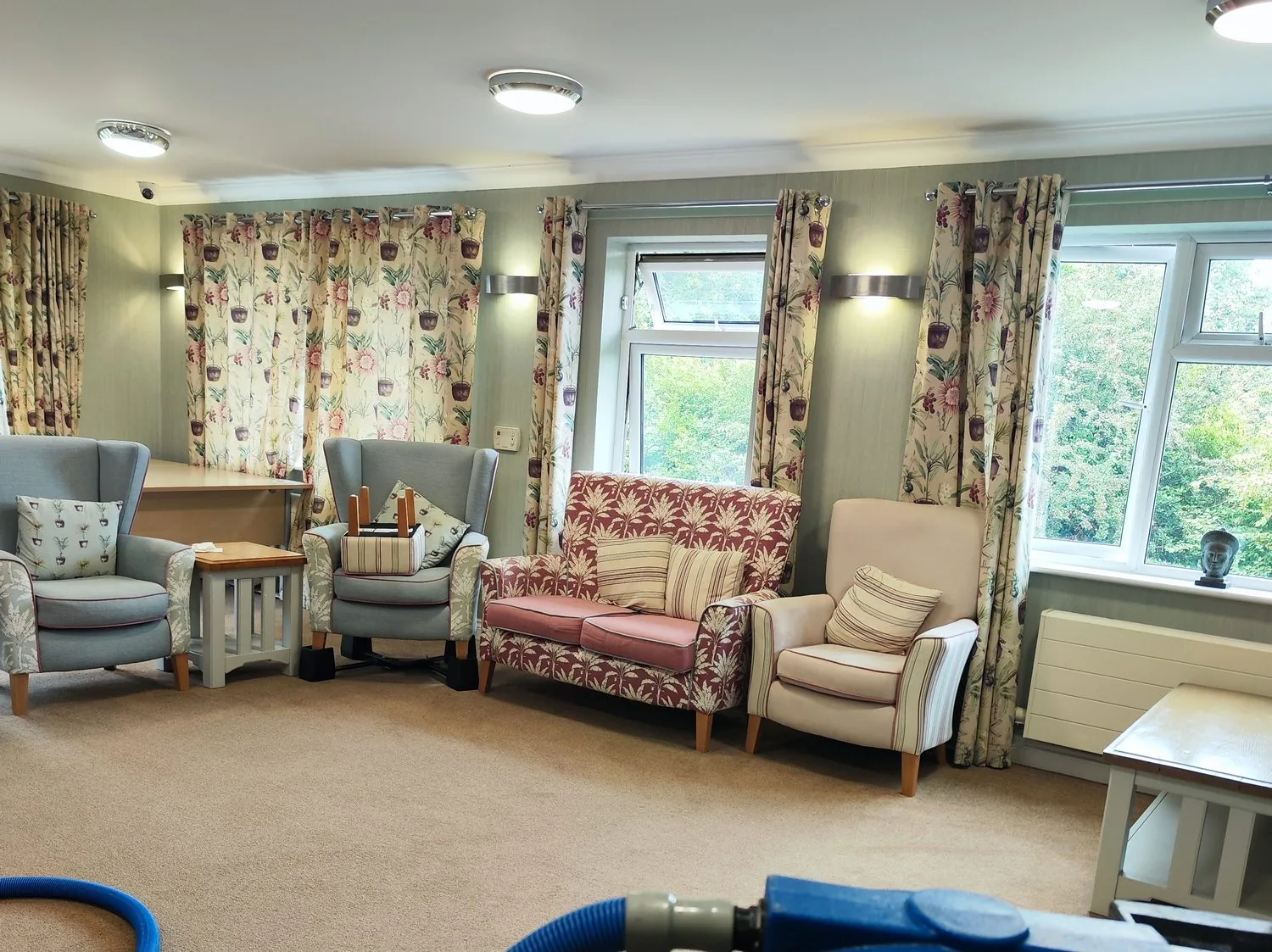 Care home lounge with extraction equipment set up for carpet cleaning