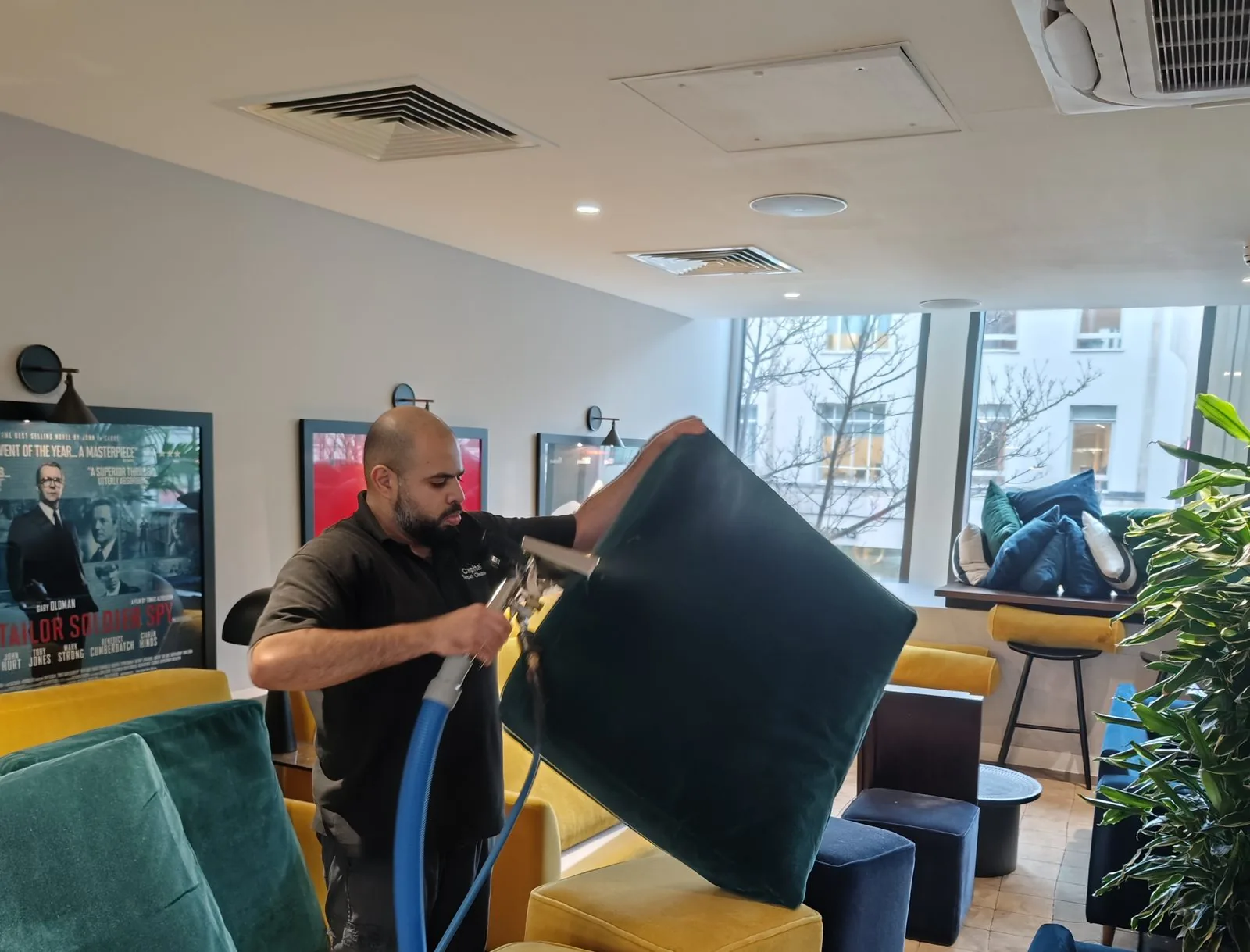 Technician extraction cleaning velvet lounge cushions