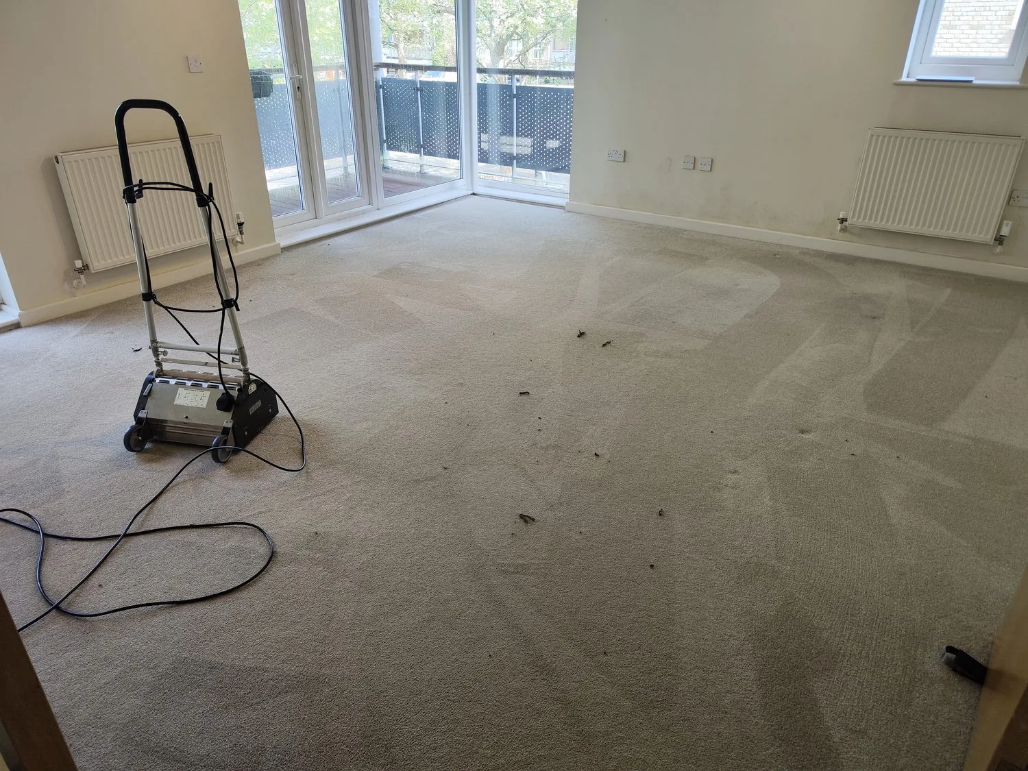 Carpet cleaning machine in an empty London flat being cleaned to checkout standard at end of tenancy