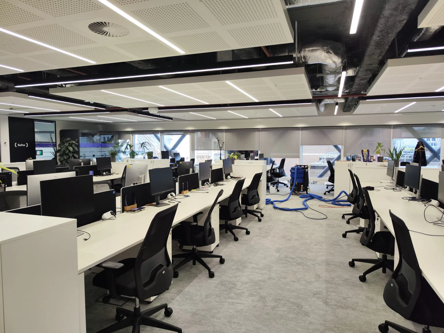 Capital Carpet Cleaners extraction machine mid-clean on an open-plan office floor in London