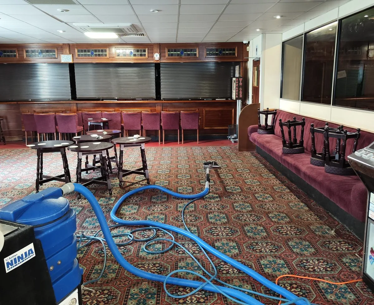 Extraction cleaning the patterned carpet of a pub function room